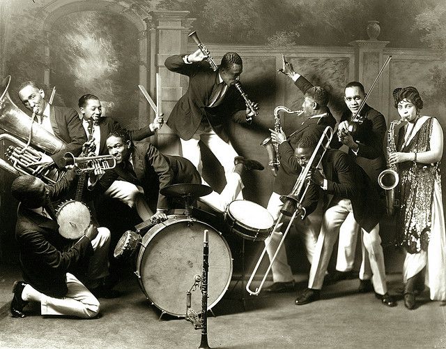 an old black and white photo of people with musical instruments