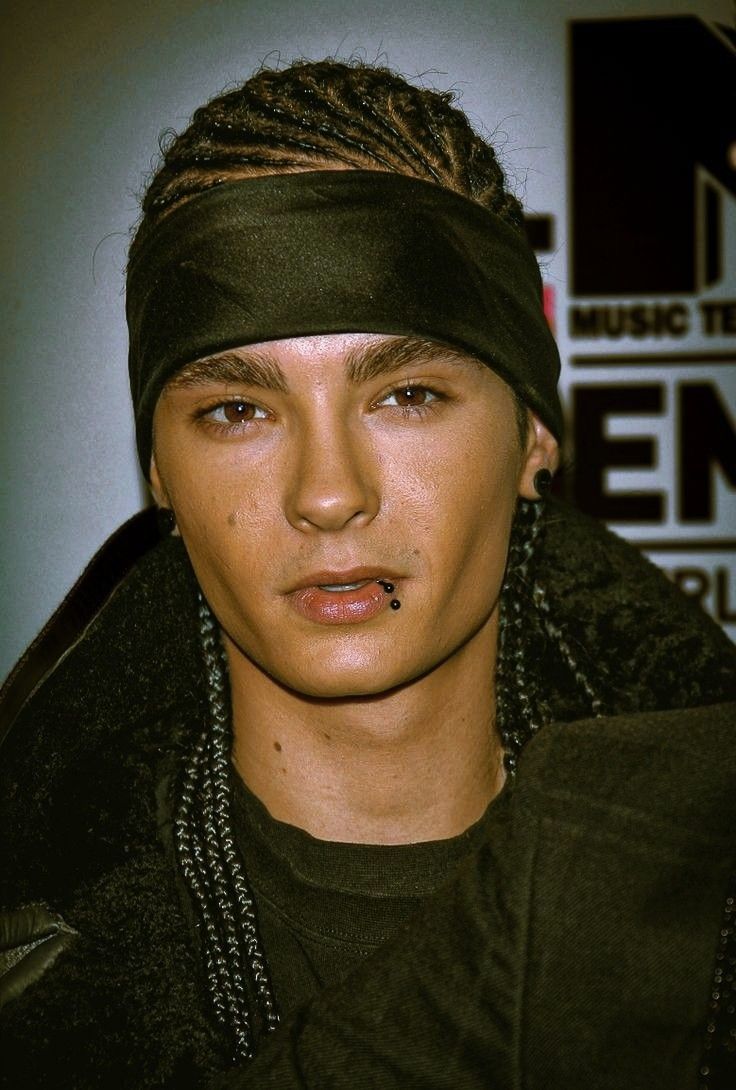 a young man with dreadlocks on his head