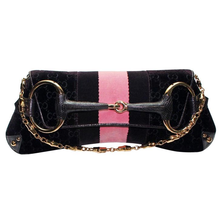 A Gucci by Tom Ford Evening Bag Limited Edition only sold in selected Gucci flagship stores Beautiful eggplant velvet with the famous GG logo monogram Exotic lizard skin trimmings - no print! Famous Gucci signature horsebit design Velvet web stripe Gold-colored hardware Detachable strap in the famous bamboo design, engraved with "Gucci" Studded One inner pocket Fully lined in fine pink satin fabric Large size, approx. 15.5" x 6.5" Made in Italy Gucci Pochette, Bamboo Purse, Gucci By Tom Ford, Tom Ford Gucci, Gucci Vintage Bag, Lizard Skin, Gucci Horsebit, Gucci Bamboo, Gg Logo