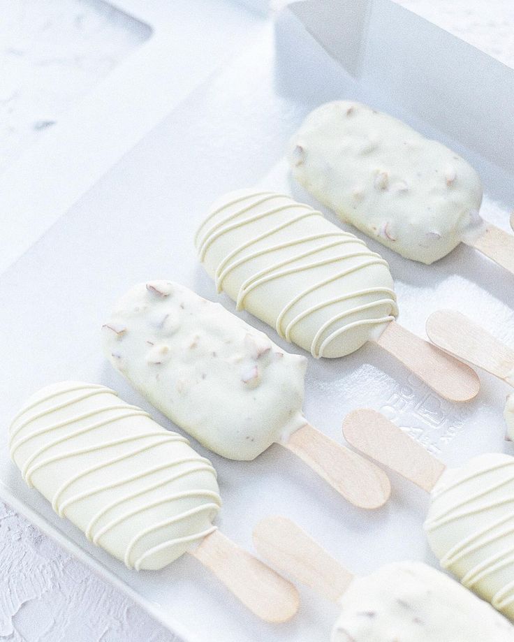 several popsicles with white frosting are in a box