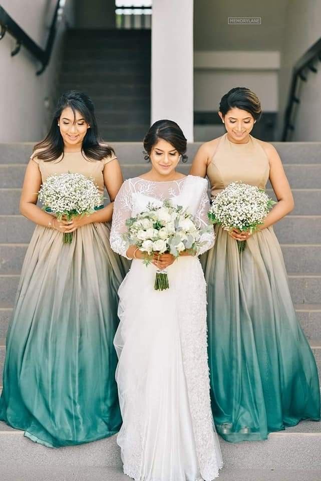 three bridesmaids are standing on the stairs with their bouquets in front of them