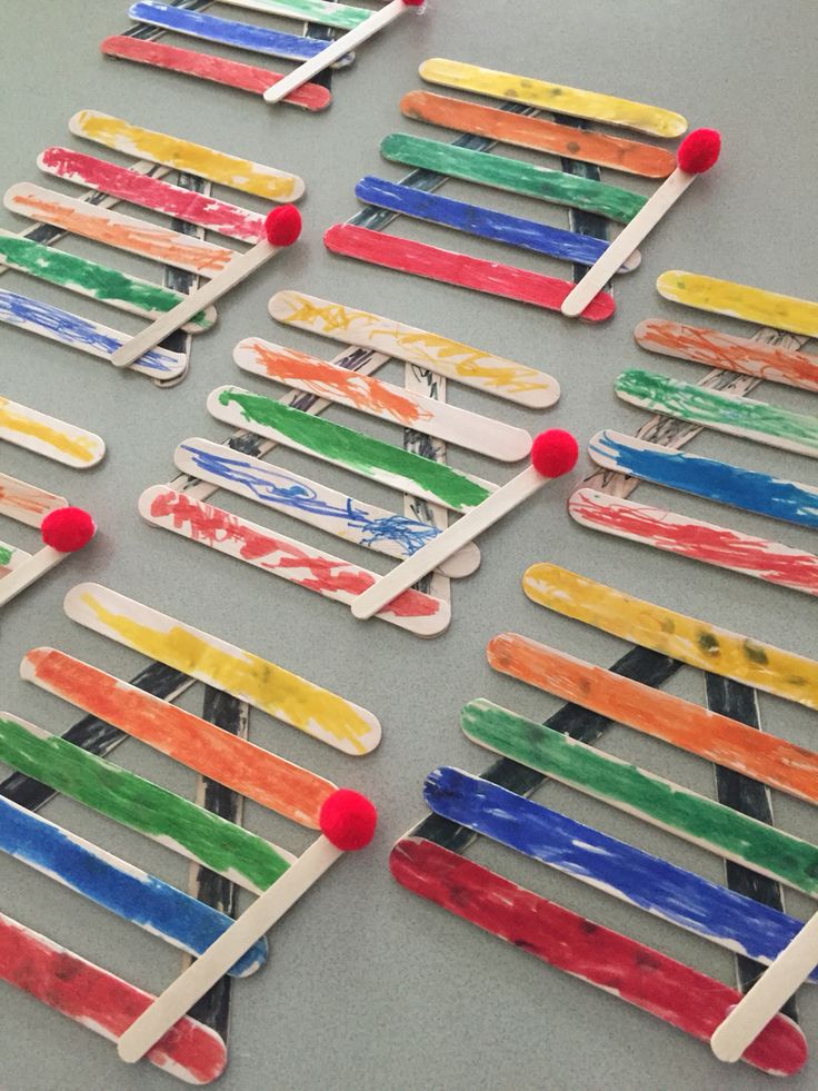 popsicles made out of toothpicks are sitting on a table with pins stuck to them