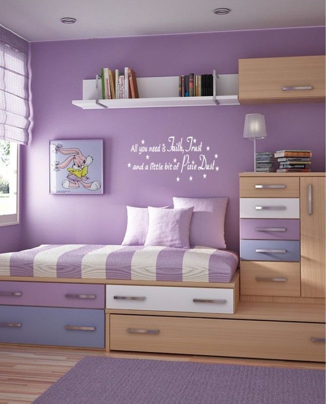 a bedroom with purple walls and white drawers in the corner, there is a quote on the wall that says try to be a rainbow in someone's cloud