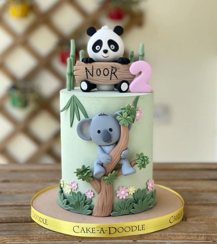 a cake decorated with a koala bear on top of a tree