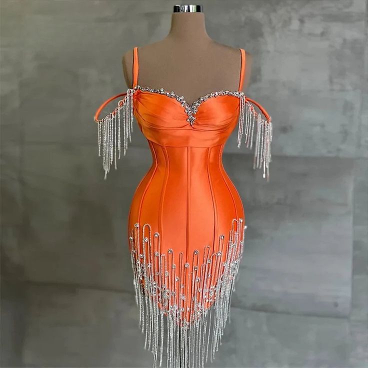 Turn heads and make a dazzling entrance with our Luxe Crystal Fringe Satin Dress. This stunning piece is a perfect blend of elegance and glamour, designed to make you the center of attention at any event. Crafted from high-quality satin, this dress offers a smooth, lustrous finish that radiates sophistication. The radiant orange hue adds a bold splash of color that effortlessly enhances your natur.. Embellished Satin Evening Dress For Prom, Sequin Satin Cocktail Evening Dress, Embellished Satin Evening Dress For Banquet, Embellished Satin Evening Dress For Banquets, Embellished Satin Dress For Prom Season, Embellished Satin Dress For Banquet, Embellished Satin Dress For Banquets, Glamorous Satin Evening Dress With Sequins, Glamorous Embellished Satin Evening Dress