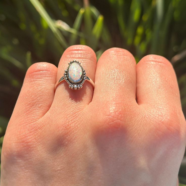 ☉ Metal Type: Sterling Silver. ☉ Metal Stamp or Hallmark: .925 ☉ Metal Purity: 92.5% Sterling. ☉ Finish: Oxidized ☉ Stone: White Lab Opal ☉ Face Measurements From South To North: 11.4mm Custom orders welcome! Oval Opal Promise Ring, Oval Opal Ring In White Gold, Silver Oval Opal Birthstone Ring, Silver Opal Birthstone Ring Oval Shape, Dainty Oval Cabochon Ring, Heirloom Opal Rings With Oval Shape, Heirloom Opal Oval Rings, Oval Opal Birthstone Ring, Oval White Gold Opal Ring Gift