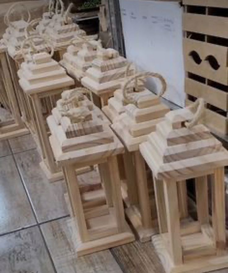 several wooden lanterns are lined up on the floor