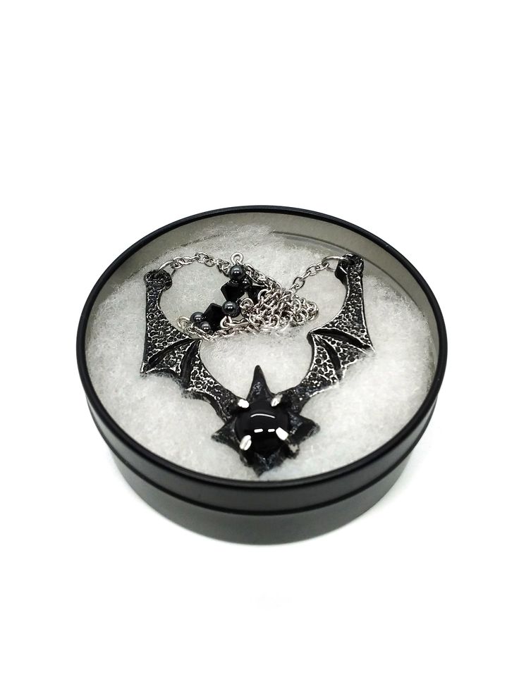 Made to Order! Dramatic, imposing and vampiric as you are, this bat wing necklace will complete your nocturnal ensemble. Stalk the halls of your dwelling or favorite events and capture the attention of your fellow night creatures with its unique design, sculpted in our studio. The pendant is cast in lead free pewter by hand and weathered, then set with a glass or stone cabochon. The chain is accented with hand beaded elements for a finishing touch. It can be layered with one of my rosary chains, Black Metal Necklace For Cosplay, Black Necklace For Halloween Cosplay, Black Fantasy Necklaces For Parties, Adjustable Black Vampire Style Necklaces, Adjustable Black Vampire Necklace, Black Vampire Pendant Jewelry, Black Metal Fantasy Necklace, Black Mystical Jewelry For Halloween, Black Fantasy Pendant Necklace