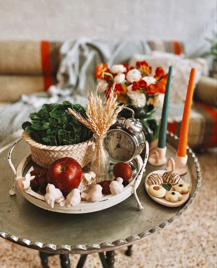 a table topped with plates and bowls filled with food on top of a metal tray