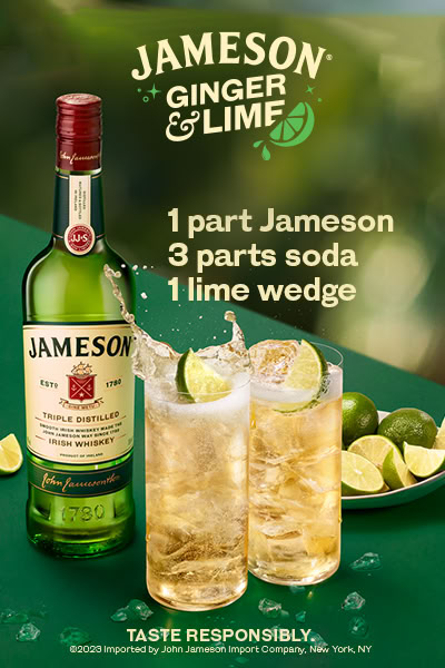 a bottle of jameson and two glasses with limes