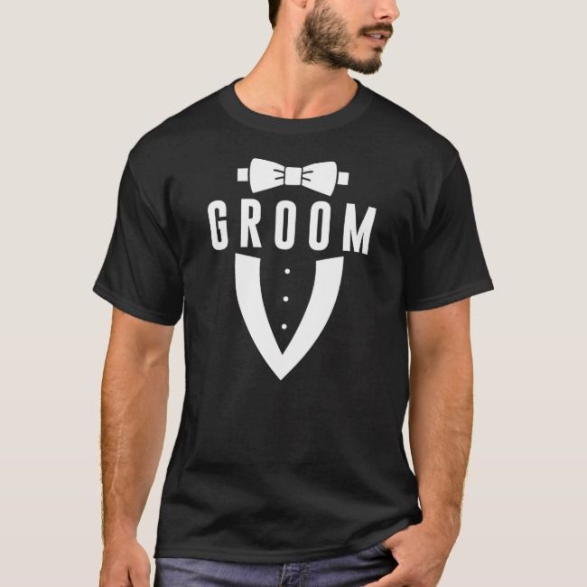 a man wearing a black t - shirt with the word groom on it and bow tie