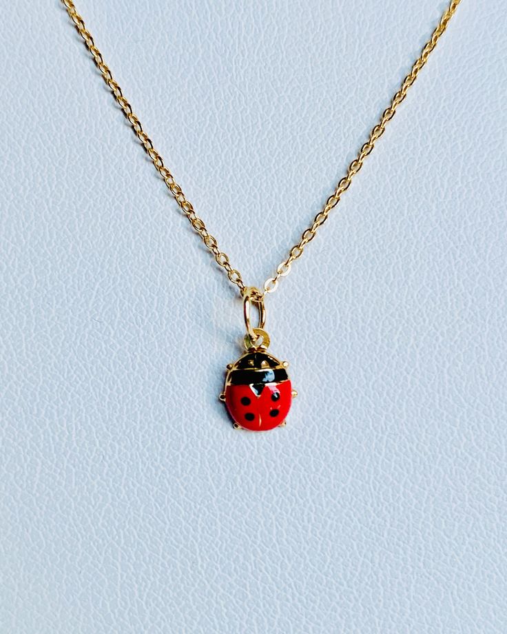 "A beautiful 14K yellow gold Red and Black Lady Bug puffy charm / pendant with hand painted and baked enamel. It has a soldered ring to attach to a bracelet or a necklace. The small pendant measures around 7mm by 6mm. It can be used as a necklace pendant or a bracelet charm and would make a perfect gift. The pendant can be paired with a shiny 14K Yellow Gold 1.2mm cable link chain in either 16\" or 18\" length or with a 16\" 14K gold-plated cable link chain. All items are packaged ready to be gi Handmade Yellow Gold Enamel Necklaces, Handmade Yellow Gold Enamel Necklace, Red Enamel Round Pendant Necklace, Black Enamel Oval Necklace As Gift, Black Enamel Oval Necklace For Gift, Yellow Gold Enamel Round Pendant Charm Necklace, Yellow Gold Enamel Charms For Gift, Yellow Gold Enamel Necklace For Gift, Dainty Yellow Gold Enamel Necklace