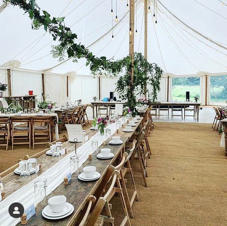 a large tent with tables and chairs set up for an event