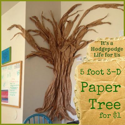 there is a paper tree on the wall next to a blue chair and a sign that says it's a holidepopge life for us