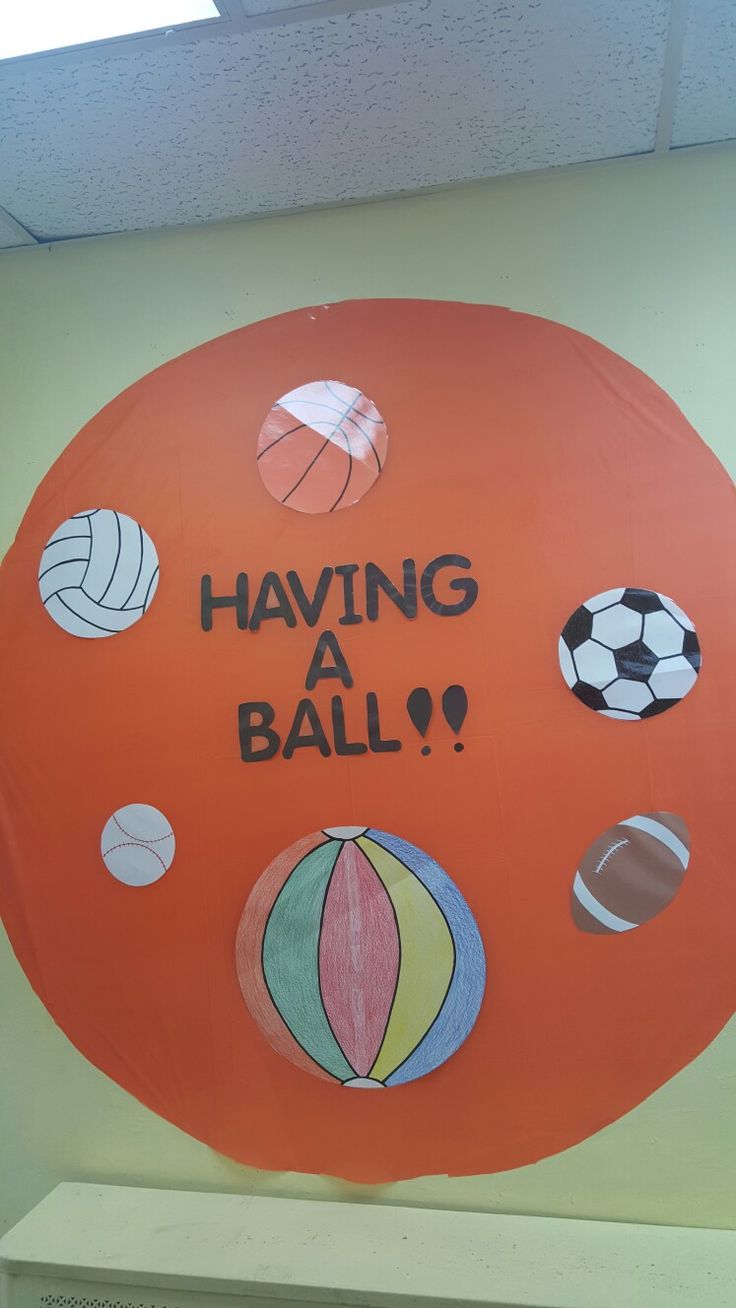 a sign that says having a ball hanging from the side of a wall with balls on it