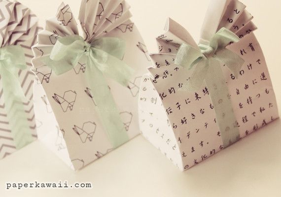 three small gift bags with bows on them