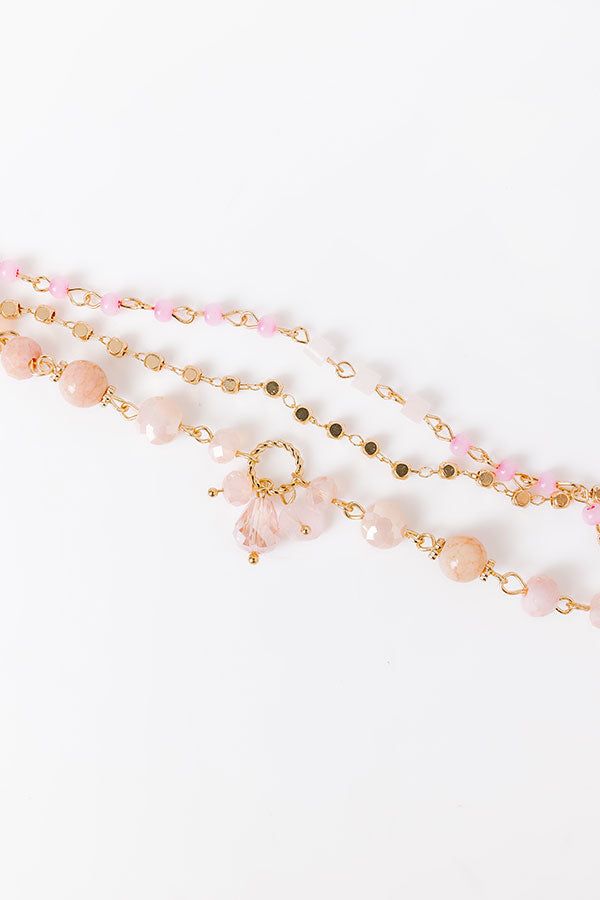 - Style your OOTD with a luxe touch with this beautiful bracelet. The trendy layered design effortlessly elevates your look. - Gold colored metal material - A layered design with three strands of stone beads and shimmering faceted beads - An adjustable length chain and clasp closure - Size: 6.5-8.5 inches Pink Faceted Bracelet Jewelry, Elegant Pink Beaded Chain Bracelet, Pink Faceted Jewelry Bracelet, Pink Double Strand Beaded Jewelry, Pink Beaded Double Strand Jewelry, Pink Double Strand Gemstone Beads Jewelry, Pink Multi-strand Jewelry For Party, Adjustable Double Strand Pink Jewelry, Pink Multi-strand Bracelet Gift