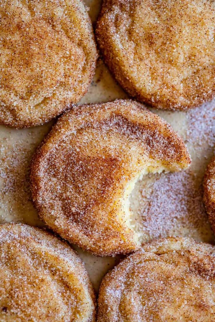 some sugared donuts are sitting on a table