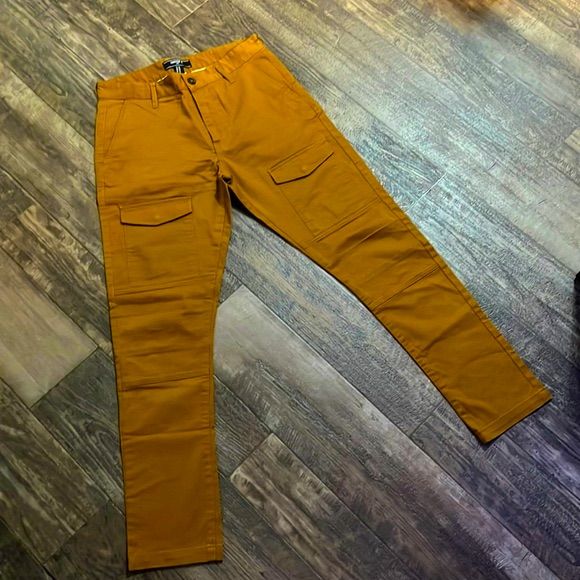 This Stylish Pair Of Men's Cargo Jeans Feature A Zip Fly With Button Closure, Belt Loops, Front Slant And Back Flap Pockets, And Side Cargo Pockets. Content + Care = 97% Polyester, 3% Spandex - Machine Wash Cold. Accepting Reasonable Offers Today Fitted Orange Bottoms With Pockets, Forever 21 Casual Straight Pants, Forever 21 Straight Leg Bottoms With Pockets, Forever 21 Cotton Bottoms For Fall, Mustard Bottoms With Pockets For Fall, Fall Forever 21 Straight Leg Bottoms, Casual Orange Straight Leg Pants, Casual Cotton Pants By Forever 21, Forever 21 Brown Bottoms For Fall