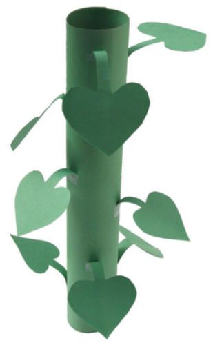 a green vase with hearts on it is sitting in the middle of a white background