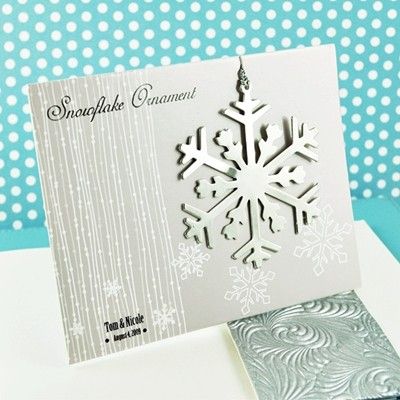 a snowflake ornament is on top of a card