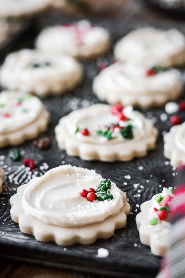 small cookies with white icing and holly decorations