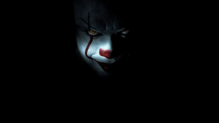 the evil clown is in the dark with his face painted white and red on it's nose