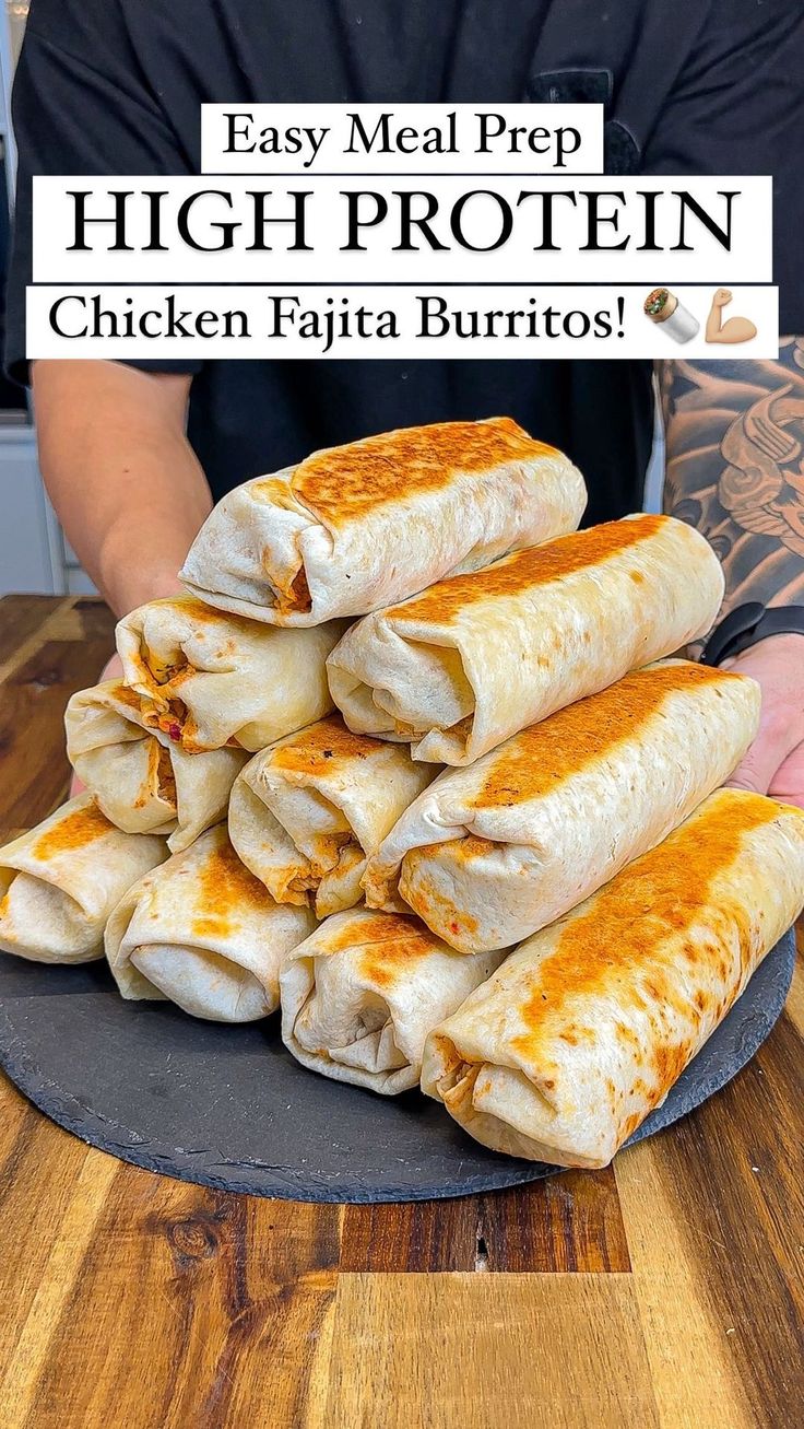 a man holding a plate full of chicken fajita burritos with the words easy meal prep high protein chicken fajita burritos