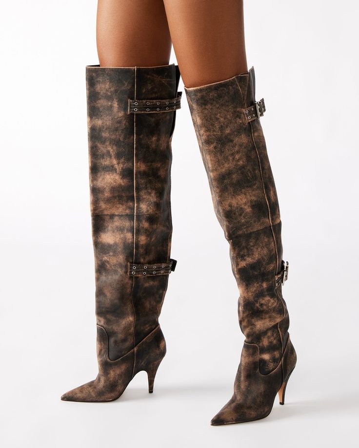 Expertly crafted, the BADDIE boot is both edgy and practical. Made with a pointed toe and buckle detail, these over-the-knee heeled boots offer a unique touch to any outfit. Elevate your style with these statement boots. 3.5 inch heel height Size 6 measurements: 16.5 inch shaft circumference, 22 inch shaft height Size 8 measurements: 17.25 inch shaft circumference, 22.5 inch shaft height Size 10 measurements: 18 inch shaft circumference, 23 inch shaft height Leather upper material Vegan leather Edgy Knee-high Boots With Buckle Closure, Edgy Over-the-knee Boots For Fall, Edgy Leather Knee-high Boots With Buckle Closure, Fitted Heeled Boots With Buckle Closure And Pointed Toe, Edgy Knee-high Heeled Boots With Buckle Closure, Edgy Over-the-knee Platform Boots For Fall, Trendy Moto Boots With Buckle And Pointed Toe, Wide Calf High Heel Boots With Buckle Closure, Fall High Heel Boots With Buckle Closure