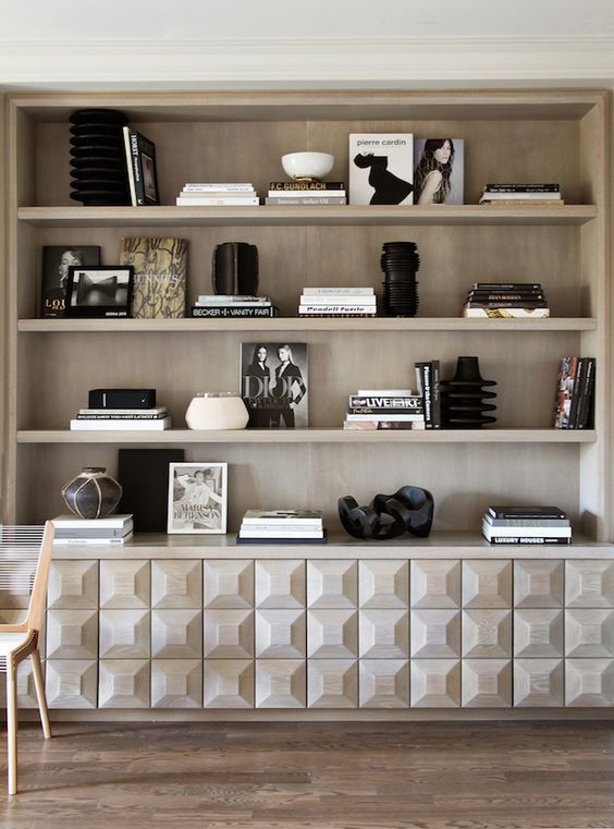 a book shelf with books and pictures on it