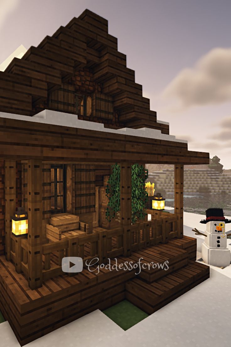 a snowman is standing in front of a small wooden house with lights on it