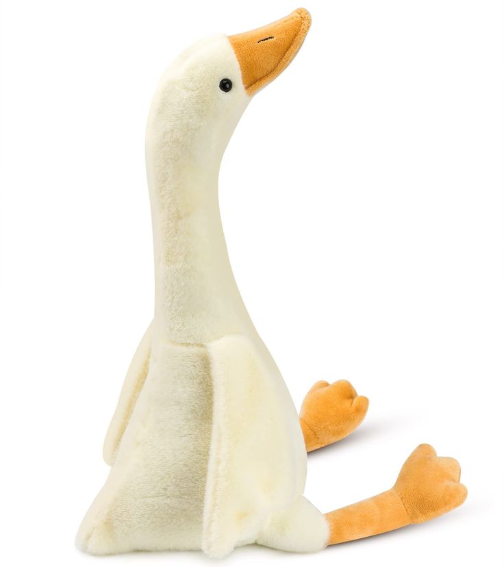 a stuffed duck sitting on the ground with it's legs spread out and eyes closed