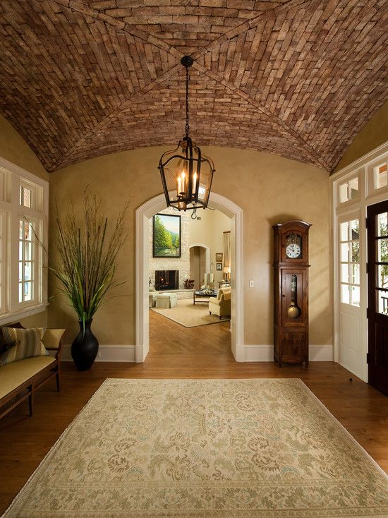 an archway leading to a living room with a clock on the wall next to it