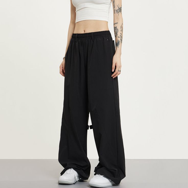 5ft 4''(166cm) tall, 95 lbs(43kg) weight and wearing a size S - BLACK- Wide baggy fit Stretch Wide-leg Parachute Pants For Streetwear, Baggy Black Cargo Pants For Sports, Black Techwear Gym Bottoms, Black Cargo Pants With Loosely Fitted Hips For Streetwear, Oversized Black Cargo Pants For Streetwear, Loosely Fitted Black Cargo Pants For Streetwear, Sporty Wide Leg Black Cargo Pants, Sporty Wide-leg Black Cargo Pants, Solid Wide-leg Pants For Streetwear