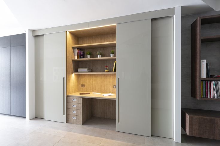 an empty room with a desk and bookshelf on the wall next to it