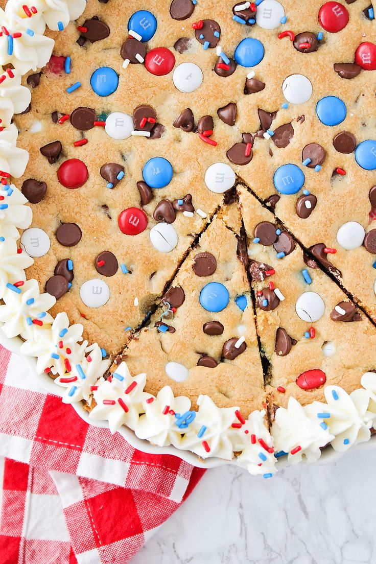 a cookie cake with white frosting and red, white, and blue sprinkles