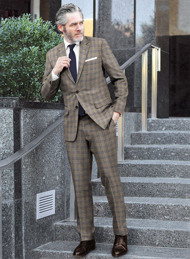 Seal your formal look with a suave piece like our Reda Sand Brown Checks Wool Suit. Tailored using superior-quality wool material, this suit is a must-have addition to your esteemed collection. The overcheck pattern, featuring blue yarns on a calm brown tone, reflects an updated vision of luxury tailoring. For men who wish to dress in a more upscale manner, this suit is a perfect choice. 
 
 Look Includes   Reda     Sand     Brown     Checks     Wool  Fabric  Two Button Jacket Style  Notch Lapel Tailored Dapper Suits For Work, Dapper Tailored Suits For Workwear, Plaid Suit With Suit Collar For Work, Tailored Plaid Suits For Business Casual, Tailored Plaid Suits For Business, Dapper Fitted Suits For Workwear, Plaid Notch Lapel Suit For Business Casual, Dapper Suit With Suit Collar For Workwear, Dapper Fitted Workwear Suits