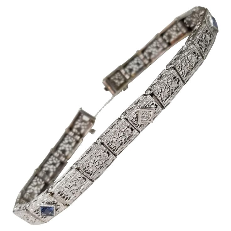 Beautiful women's Art Deco style filigree bracelet in 14k white gold. This bracelet features 1 round brilliant cut diamonds and 2 square cut sapphires. The bracelet has a solid clasp and safety. *Motivated to Sell – Please make a Fair Offer* Specifications: main stone: ROUND CUT additional: DIAMONDS carat total weight: .05 CARAT TOTAL WEIGHT color: H clarity: VS1 additional: 2 square cut sapphires .14pts brand: custom metal: 14k white gold type: BRACELET weight: 17.1 grS length: 7 inch with safe Levian Jewelry, Filigree Bracelet, Yellow Gold Bangle, Gold Link Bracelet, Art Deco Bracelet, Gold For Sale, Le Vian, Floral Bracelet, White Gold Bracelet