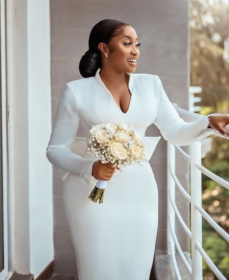 a woman in a white dress holding a bouquet