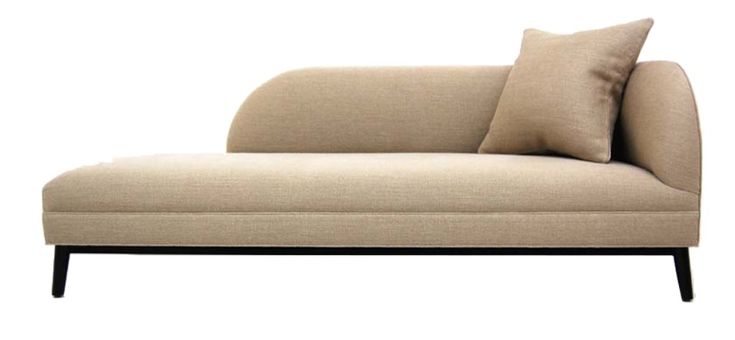 a beige couch with two pillows on it's back and the seat upholstered