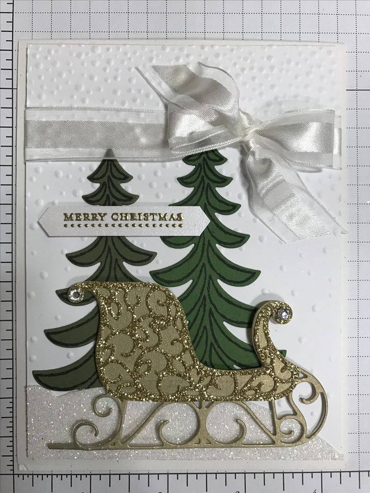 a christmas card with a sleigh and trees