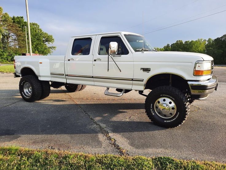 a white pickup truck parked in a parking lot