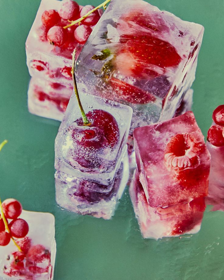 ice cubes with cherries on them and water