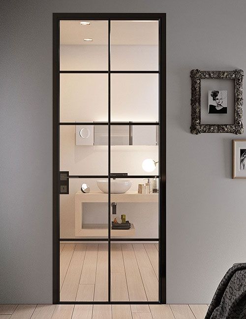 an open door leading to a bathroom with a sink and mirror on the wall in front of it