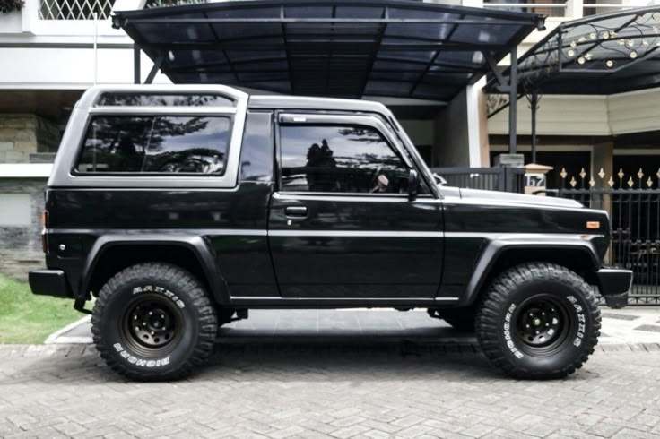 a black jeep parked in front of a building