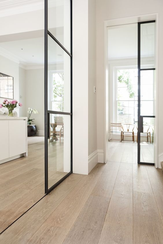 an empty room with wooden floors and white walls