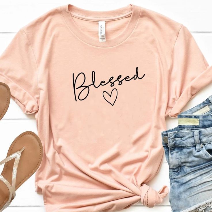 Blessed T-Shirt | Wear this t-shirt with pride knowing that a % of your purchase goes towards spreading the word of God. Part will go to building new churches, and part will go to sending missionaries around the world. Our Blessed T-Shirt is not only adorable but extremely soft too! Its bold Message will be sure to turn heads!  #tshirt #womenstshirt #womensfashion #christianapparel #tshirtforwomen #Love #God #Clothes #Christ #valerymilano God Clothes, The Word Of God, Indie Fashion, Christian Clothing, Christian Shirts, Summer Shorts, Word Of God, Room Ideas, Floral Tops