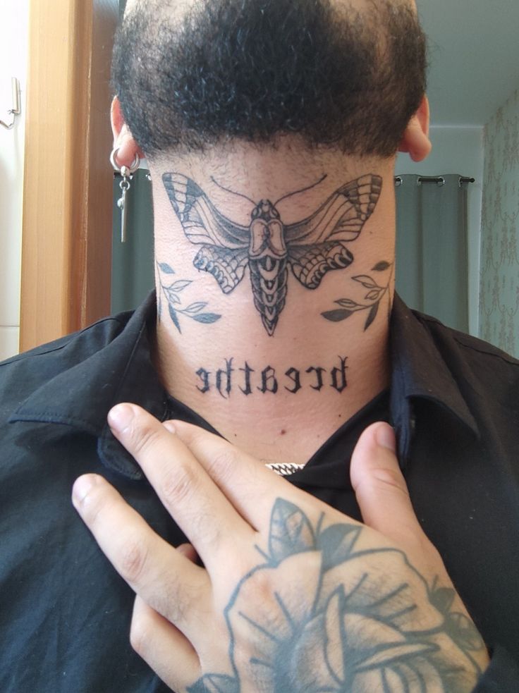 a man with a tattoo on his neck has the word breathe tattooed on his chest