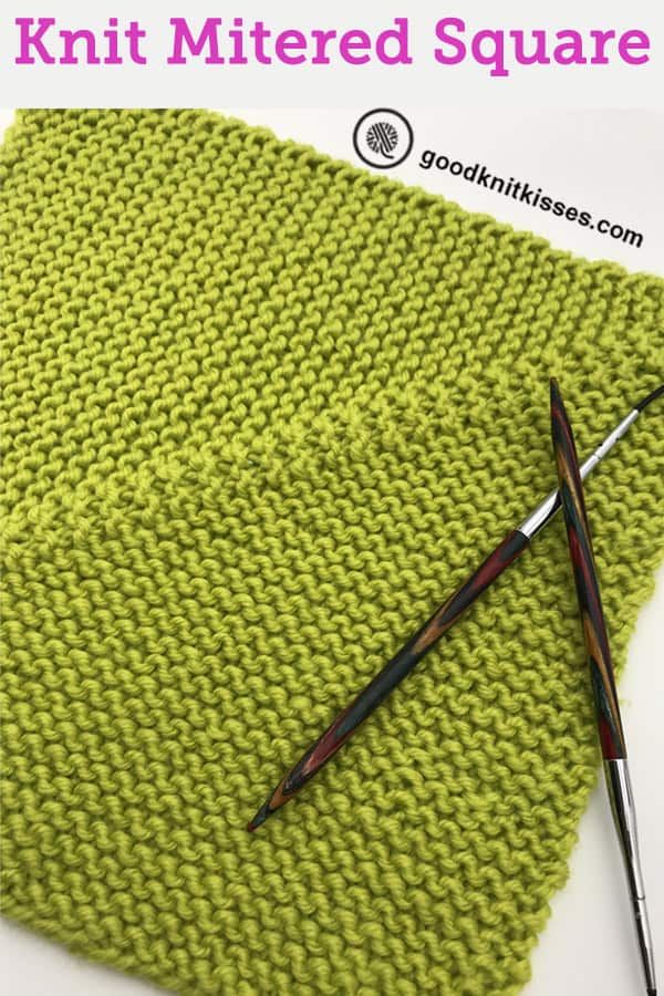 the knitted square is being worked on with two knitting needles, and another pair of scissors sits next to it