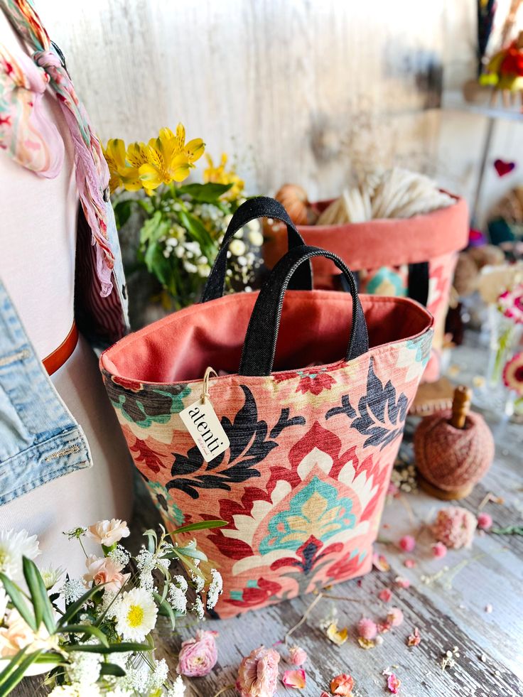 Santa Monica Hope Basket - a project bag to store all your knitterly and crocheterly creations! Crafted of 100% cotton shell with a dreamy suzani-inspired pattern, this roomy bucket bag features a roll-down top, denim handles, and a dusty rose pink velvet accent inside. Whether you're inspired by its Spanish influence, peach gray blue hue, or the ever-spectacular Santa Monica sunset, you'll want this elegant bag to join you on your crafting adventures. This generous, roomy bag stands alone, and Pink Bohemian Bucket Bag For Everyday Use, Pink Bohemian Bucket Bag For Everyday, Cotton Bucket Bag With Removable Pouch, Spring Bucket Bag With Rolled Handles, Velvet Accents, Dusty Rose Pink, Miscellaneous Items, Elegant Bags, Crochet Creations